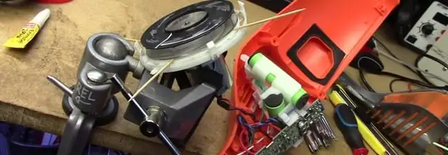 Vacuum cleaner repair parts and tools on a workbench in Sarasota, FL