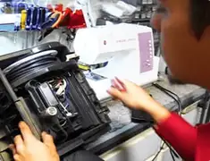 Vacuum repair technician servicing internal components on a workbench in Sarasota, FL