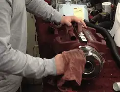 Vacuum repair technician cleaning and servicing a vacuum motor in Sarasota, FL