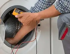 Washing machine repair technician testing a front-load washer with diagnostic tools in Sarasota, FL