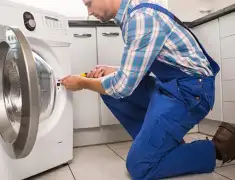 Washing machine repair technician servicing a front-load washer in Sarasota, FL